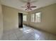 Bedroom with a pink ceiling fan, tiled floor, and sliding closet at 132 Acapulco Dr, Kissimmee, FL 34743