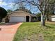 Charming single-story home featuring a well-maintained lawn, a two-car garage, and a welcoming front entrance at 132 Acapulco Dr, Kissimmee, FL 34743