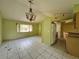 Open living area with tile flooring, ceiling fan, and a view of the kitchen at 132 Acapulco Dr, Kissimmee, FL 34743