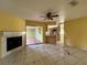 Spacious living room features tile flooring, fireplace, and backyard access at 132 Acapulco Dr, Kissimmee, FL 34743