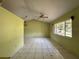 Bright living room with high ceilings, ceiling fan, and large windows offering natural light at 132 Acapulco Dr, Kissimmee, FL 34743
