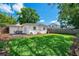 Large backyard featuring a green lawn, patio dining set, and a white house at 1424 W New Hampshire St, Orlando, FL 32804