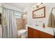Bathroom featuring a vanity with wood cabinets, a shower with tile, and a mirror at 1424 W New Hampshire St, Orlando, FL 32804