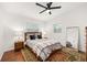 Bright bedroom featuring a ceiling fan, wood floors, an area rug, and a full-length mirror at 1424 W New Hampshire St, Orlando, FL 32804