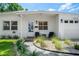 Close up of a single-story home entrance with front yard xeriscaping at 1424 W New Hampshire St, Orlando, FL 32804