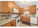 Bright kitchen features stainless steel appliances and updated wooden cabinetry at 1424 W New Hampshire St, Orlando, FL 32804
