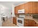 Bright kitchen features stainless steel appliances and updated wooden cabinetry at 1424 W New Hampshire St, Orlando, FL 32804