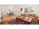 Bright living room showcasing large windows, a cozy sofa, and a decorative rug at 1424 W New Hampshire St, Orlando, FL 32804