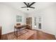Office space with wood floors, modern desk, bookshelf, and sliding glass door access to the back yard at 1424 W New Hampshire St, Orlando, FL 32804