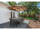 Outdoor patio space featuring a dining set with umbrella and view of the backyard at 1424 W New Hampshire St, Orlando, FL 32804