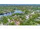 Aerial view of a house and Lake Tarpon showing community surrounded by lush greenery with serene lake views at 150 Debary Dr, Debary, FL 32713