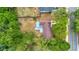 Aerial shot of a charming home featuring a lovely back deck, set amidst a backdrop of lush trees at 150 Debary Dr, Debary, FL 32713