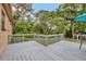 View of the wood planked rear deck overlooking the lush landscaped backyard at 150 Debary Dr, Debary, FL 32713