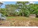 A spacious backyard with mature trees and a shed providing outdoor charm at 150 Debary Dr, Debary, FL 32713