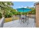 View of backyard wood deck with table and chairs and partial umbrella at 150 Debary Dr, Debary, FL 32713