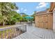 A tranquil backyard deck with an umbrella table set near an exterior storage shed at 150 Debary Dr, Debary, FL 32713