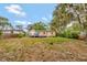 The expansive backyard features mature trees, lush lawn, and a wood privacy fence at 150 Debary Dr, Debary, FL 32713