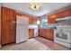 Kitchen featuring tile floors, wood cabinets, granite countertops, and white appliances at 150 Debary Dr, Debary, FL 32713