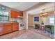 Cozy kitchen featuring tile floor, wooden cabinets, and a large window for lots of natural light at 150 Debary Dr, Debary, FL 32713