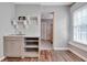 Kitchenette featuring open shelves, sink, storage, wood floors and light paint at 150 Debary Dr, Debary, FL 32713