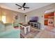 Inviting living room with modern ceiling fan, tile floors, and access to the kitchen at 150 Debary Dr, Debary, FL 32713