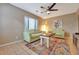 Cozy living room with bright decor, tile flooring, and a modern ceiling fan at 150 Debary Dr, Debary, FL 32713
