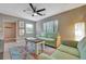Comfortable living room with a vibrant rug, plush sofa, and ample natural light streaming through the window at 150 Debary Dr, Debary, FL 32713