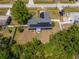 Aerial view of a fenced property featuring a home with solar panels and a well-maintained yard at 1671 Judith Dr, Kissimmee, FL 34758