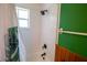 Bright bathroom featuring a shower-tub combination, classic tiles, and botanical-themed decor at 1671 Judith Dr, Kissimmee, FL 34758