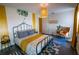 Comfortable bedroom with a wrought iron bed, stylish decor, and natural lighting at 1671 Judith Dr, Kissimmee, FL 34758