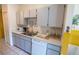 Bright kitchen featuring a stainless steel sink, white appliances, and plenty of counter space at 1671 Judith Dr, Kissimmee, FL 34758