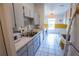 A well-maintained kitchen featuring white cabinetry, laminate countertops, and tile flooring with lots of natural light at 1671 Judith Dr, Kissimmee, FL 34758