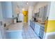 Well-lit kitchen featuring ample cabinet space, a double sink, and modern appliances at 1671 Judith Dr, Kissimmee, FL 34758