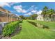 Lush backyard view between homes with pond and landscaping at 17349 Serenidad Blvd, Clermont, FL 34714