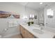 Chic bathroom boasting dual sinks, a spacious mirror, and modern lighting fixtures at 17349 Serenidad Blvd, Clermont, FL 34714