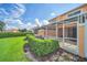 Rear exterior view of screened-in patio and lawn area at 17349 Serenidad Blvd, Clermont, FL 34714