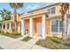 Well-maintained townhouse with a tidy landscape, featuring palm trees at 17349 Serenidad Blvd, Clermont, FL 34714
