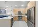Modern kitchen with stainless steel appliances, a breakfast bar, and ample storage at 17349 Serenidad Blvd, Clermont, FL 34714