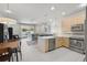 Open-concept kitchen featuring stainless steel appliances and an island at 17349 Serenidad Blvd, Clermont, FL 34714