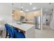 Contemporary kitchen with a stainless steel refrigerator, breakfast bar and pendant lighting at 17349 Serenidad Blvd, Clermont, FL 34714