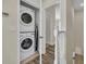 Convenient laundry closet with stacked washer and dryer adjacent to the staircase landing at 17349 Serenidad Blvd, Clermont, FL 34714