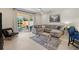 Comfortable living room showcasing a sectional sofa, decorative rug, and view of the outdoor pool at 17349 Serenidad Blvd, Clermont, FL 34714