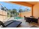 Private screened-in patio with plunge pool, lounge chairs and dining set at 17349 Serenidad Blvd, Clermont, FL 34714