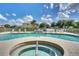 Community pool and spa area with seating and manicured landscaping at 17349 Serenidad Blvd, Clermont, FL 34714
