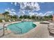 Large community pool and spa with water feature and lounge chairs at 17349 Serenidad Blvd, Clermont, FL 34714