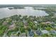 Aerial view showcases neighborhood homes surrounded by trees and views of the lake at 1761 Legion Dr, Winter Park, FL 32789