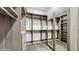 A beautifully organized walk-in closet featuring wood grain shelving, rods, and mirrored doors at 1761 Legion Dr, Winter Park, FL 32789