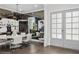Elegant dining room with modern decor, mirrored wall, stylish lighting, and sophisticated artwork at 1761 Legion Dr, Winter Park, FL 32789