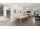 Bright dining room with a wood table, elegant light fixture, and view of the outdoor kitchen at 1761 Legion Dr, Winter Park, FL 32789