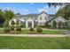 Expansive white home with dark roof, lush landscaping, symmetrical plantings, and well manicured lawn at 1761 Legion Dr, Winter Park, FL 32789